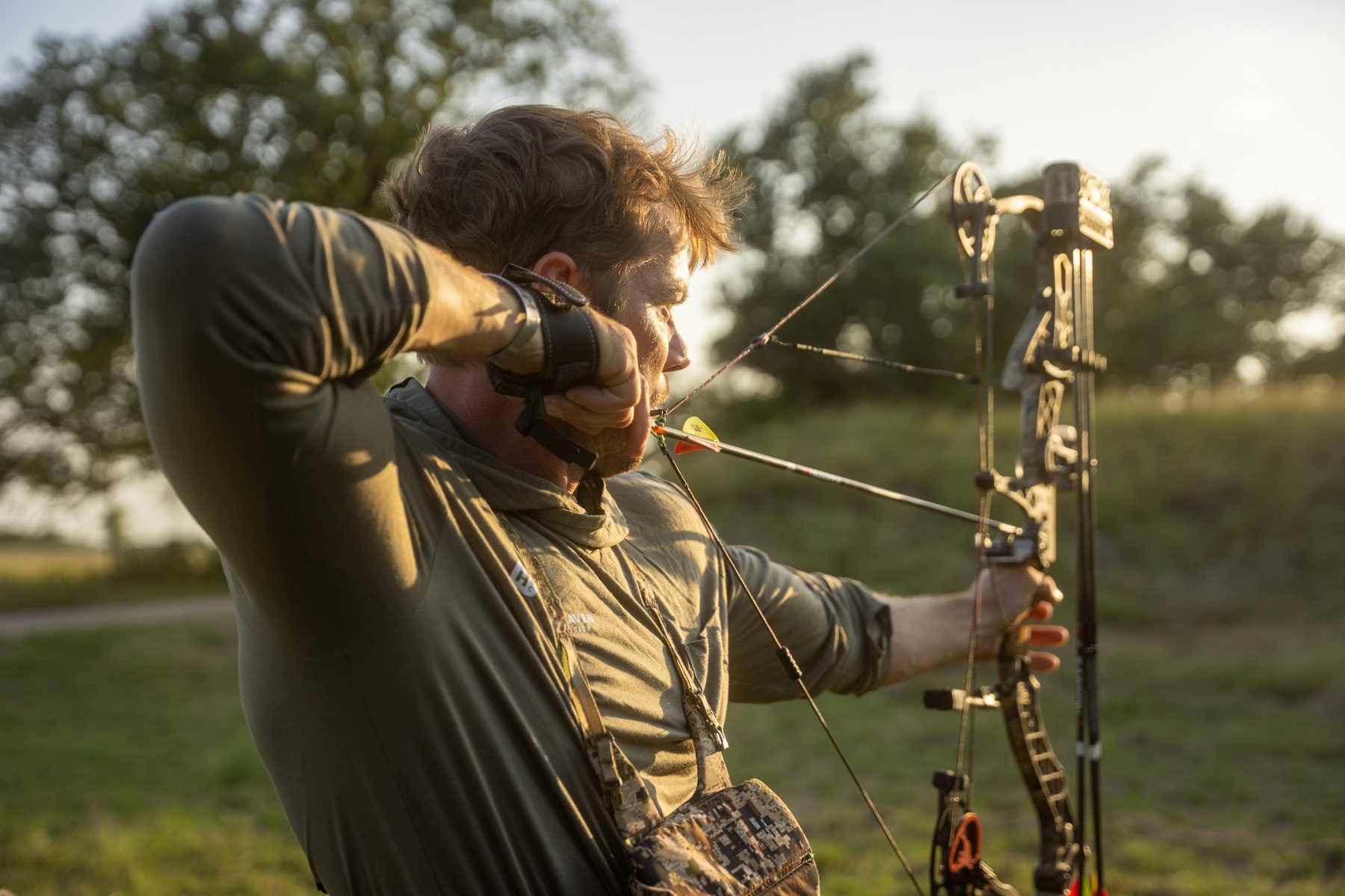 An archer drawing a compound bow