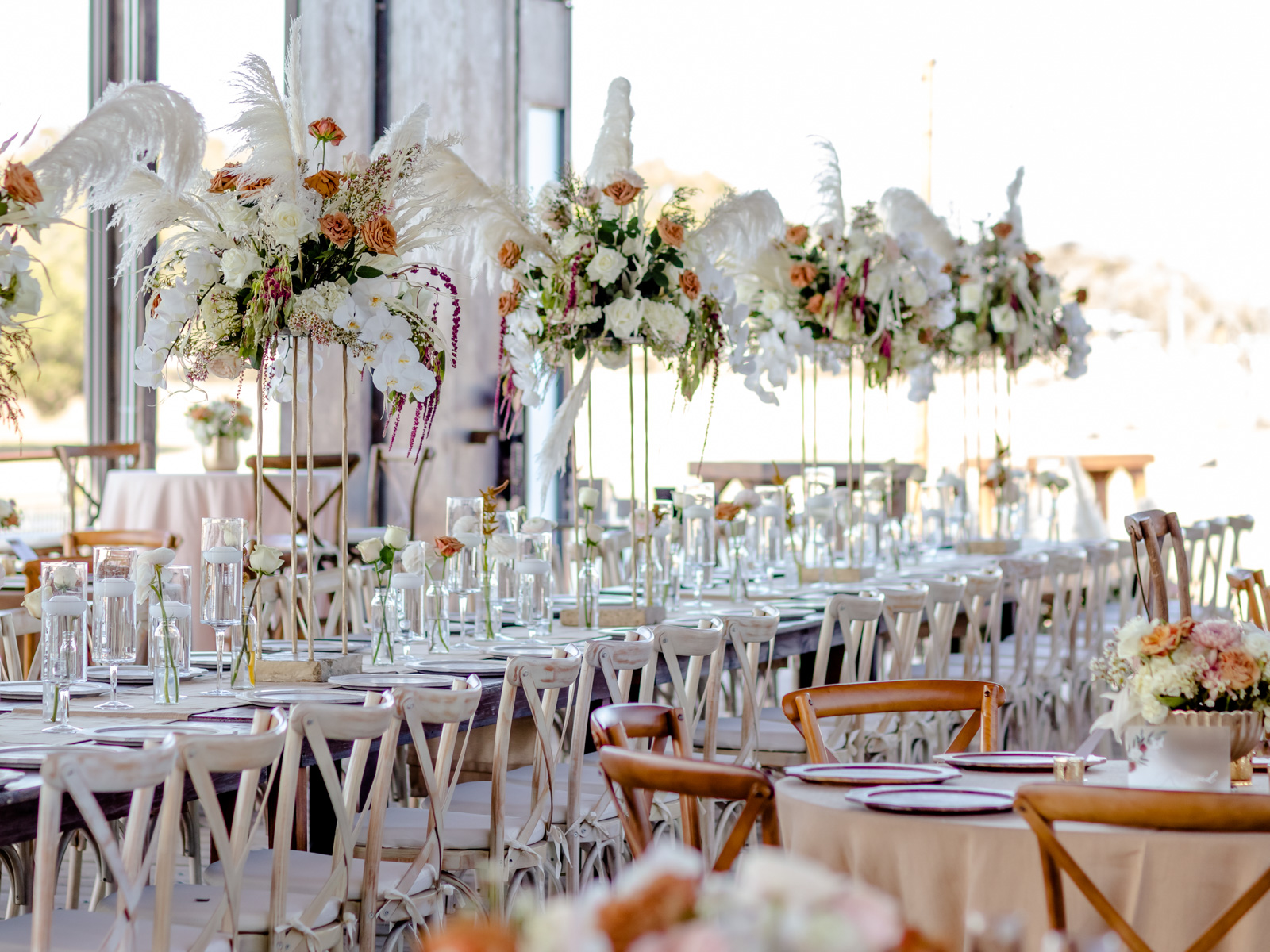 A wedding reception set for dinner in the pavilion